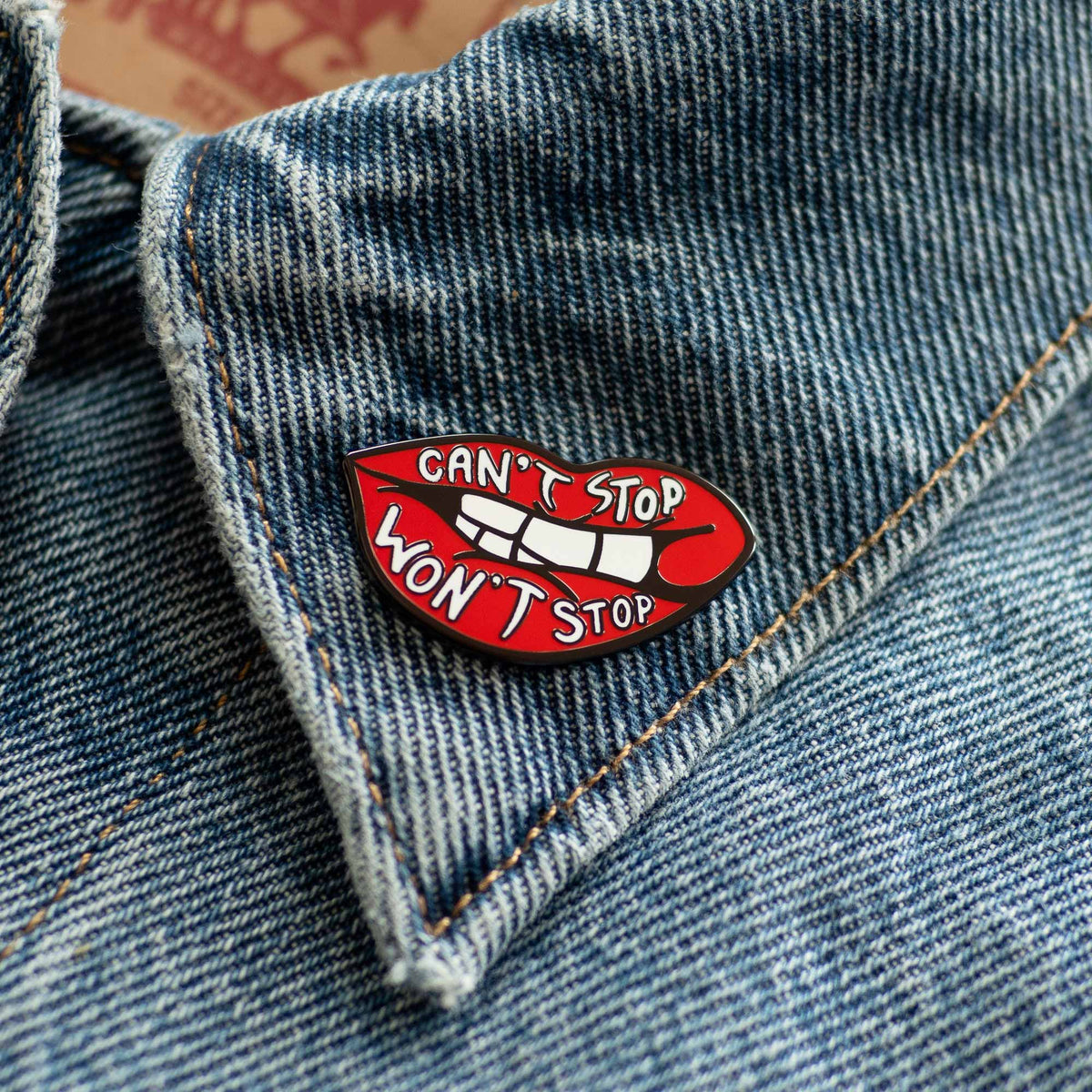 Can't Stop Won't Stop Lips hard enamel pin on denim jacket