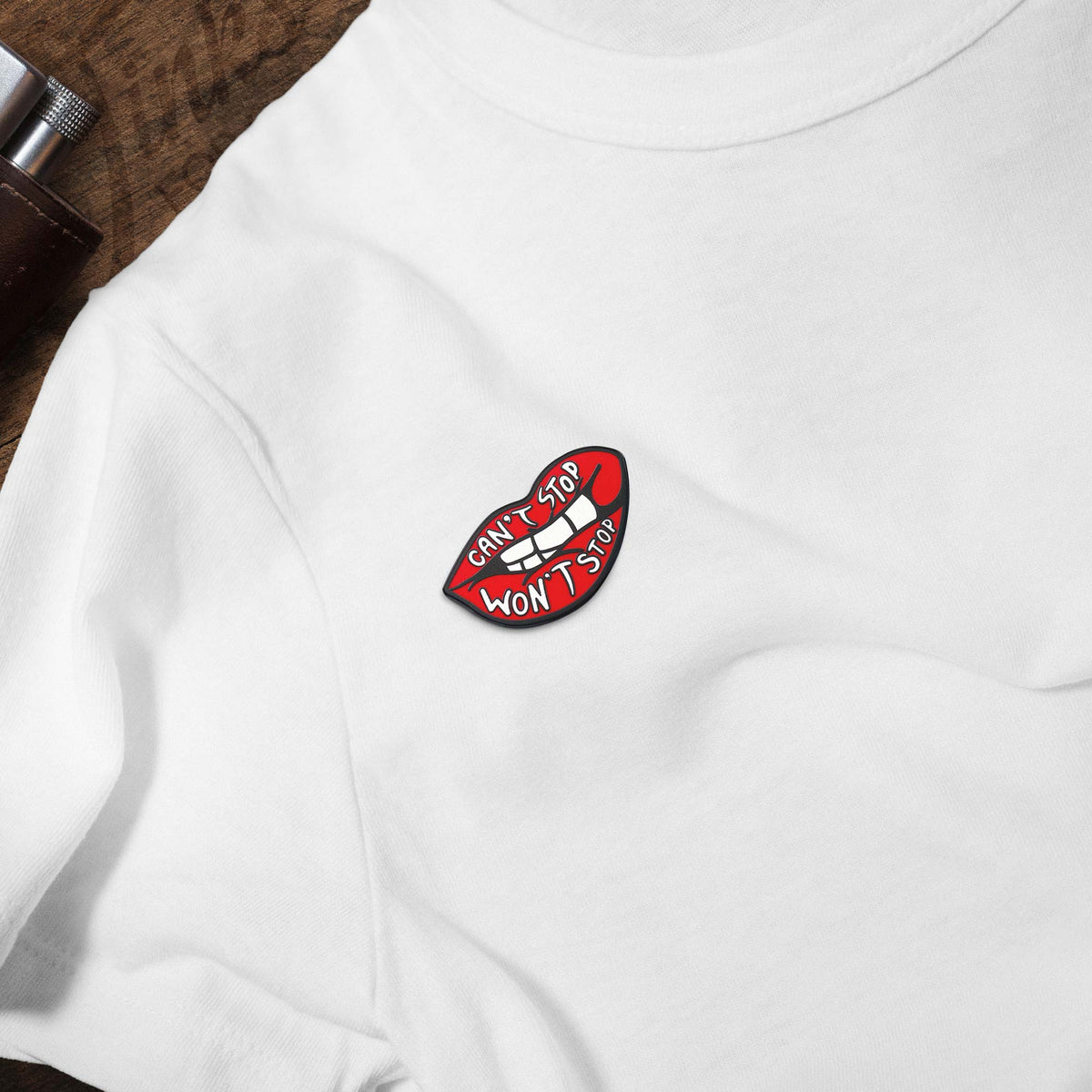 Can't Stop Won't Stop hard enamel pin on white t-shirt