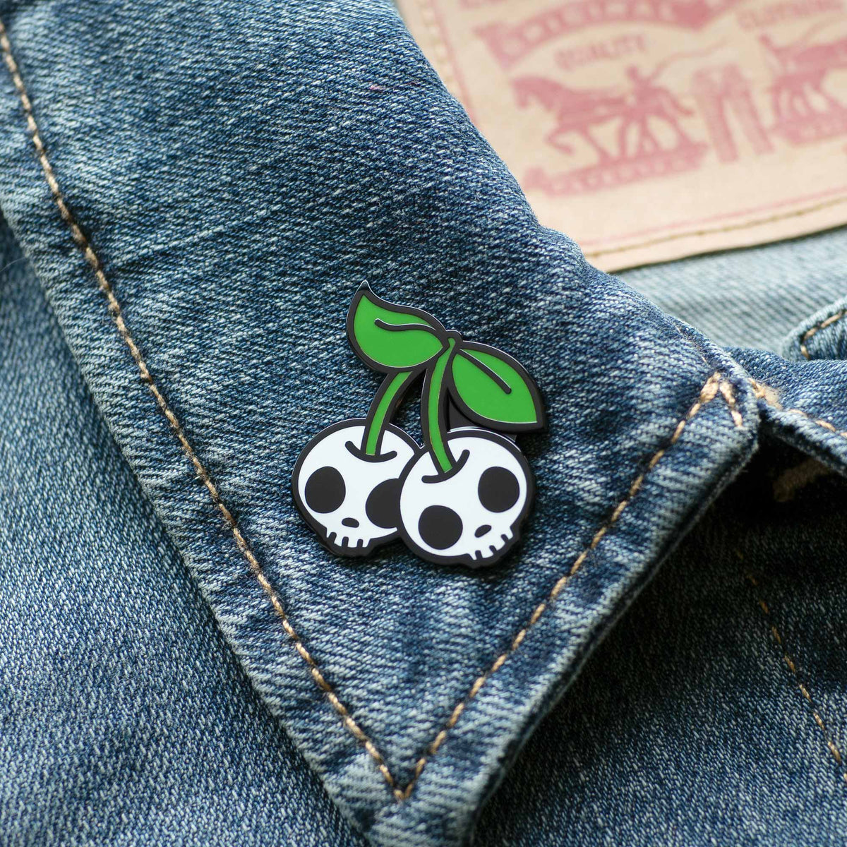 Cherry Skulls hard enamel pin on denim jacket