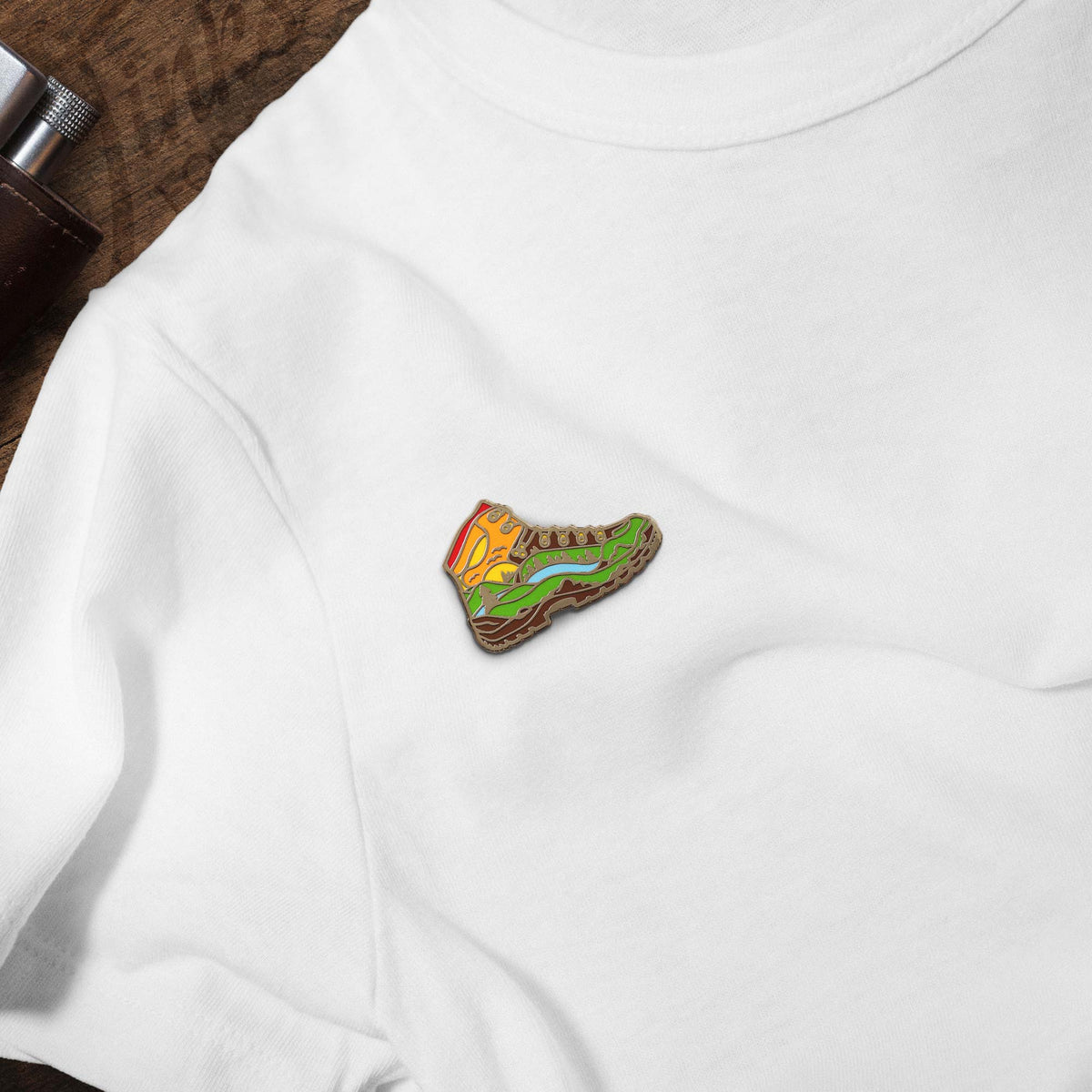 Hiked It Liked It Hiking Boot hard enamel pin on white t-shirt