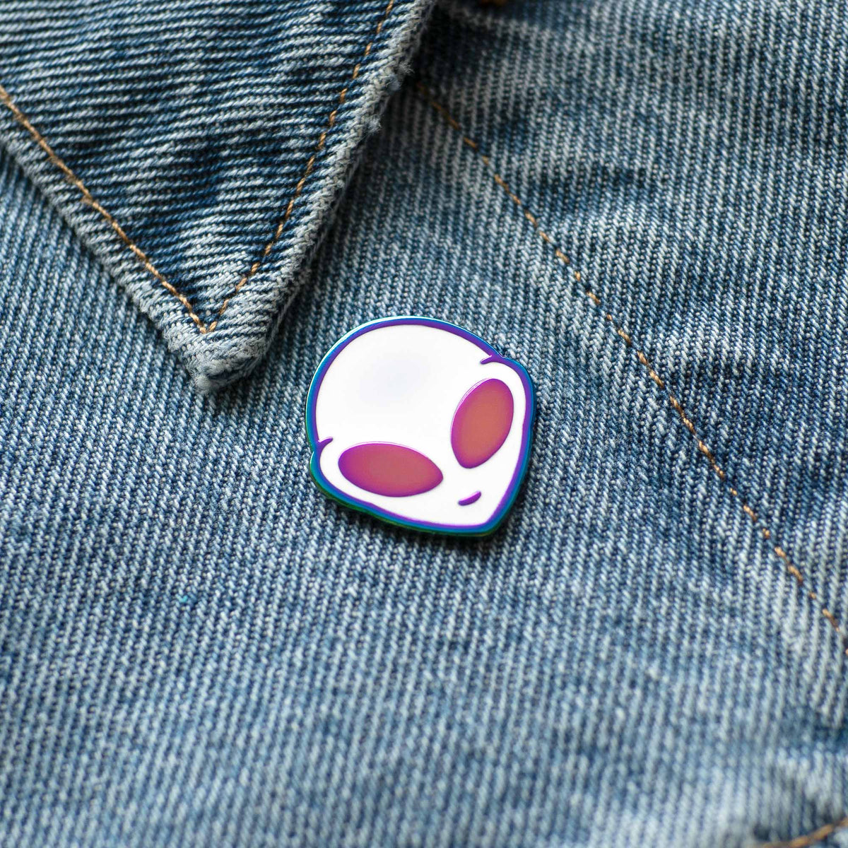 Iridescent Alien hard enamel pin on denim jacket