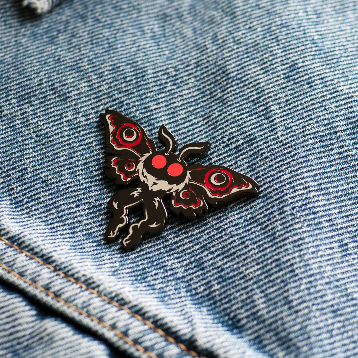 Mothman Cryptid Creature hard enamel pin on denim jacket