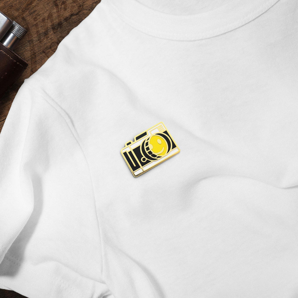 Smiley Face Vintage Camera hard enamel pin on white t-shirt