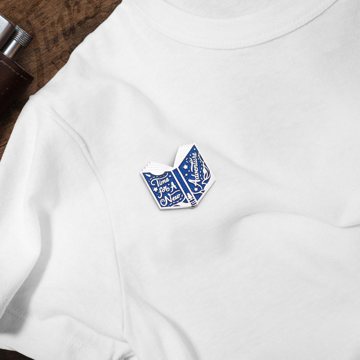 Time For A New Adventure Book hard enamel pin on white t-shirt