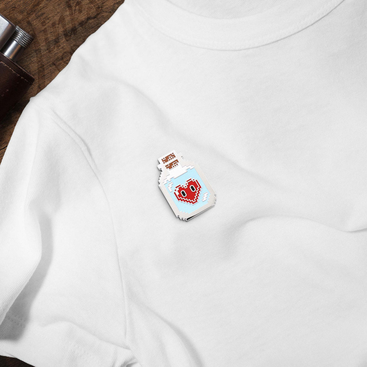 8-Bit Love Potion hard enamel pin on white t-shirt