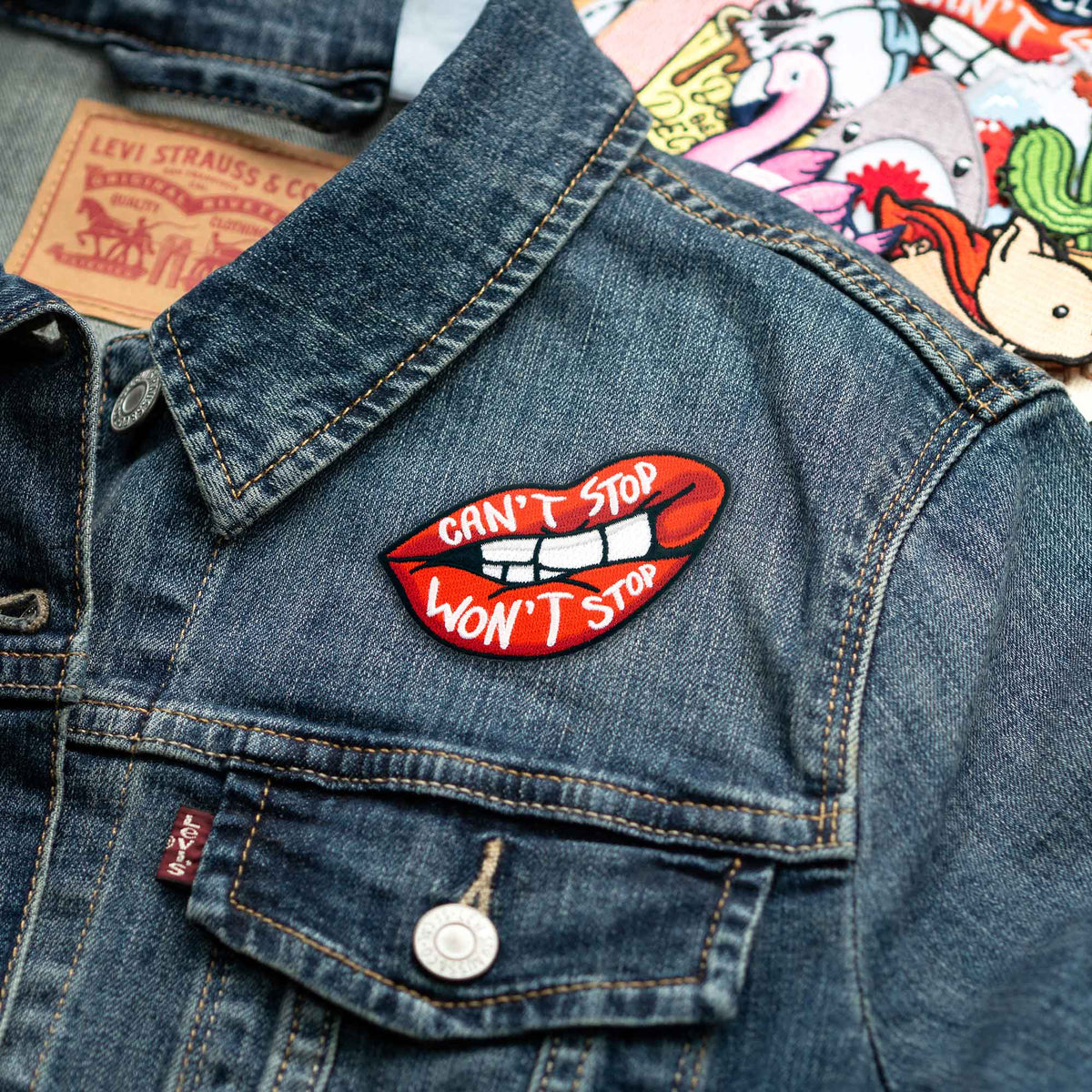 Can't Stop Won't Stop Lips patch on denim jacket