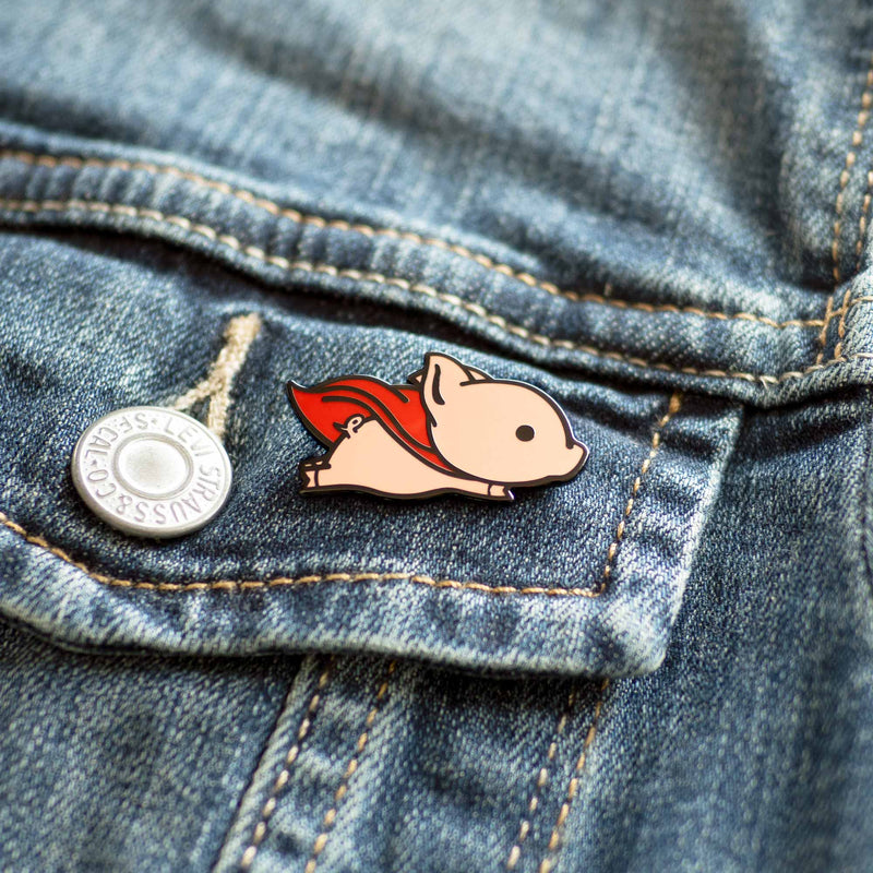 Flying Pig with Red Superhero Cape hard enamel pin on denim jacket