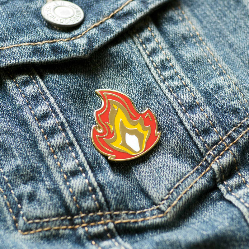 It's Fire hard enamel pin on denim jacket