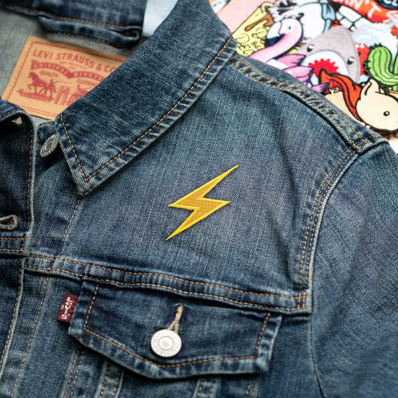 High Voltage Sign Metallic Lightning Bolt Emoji patch on denim jacket