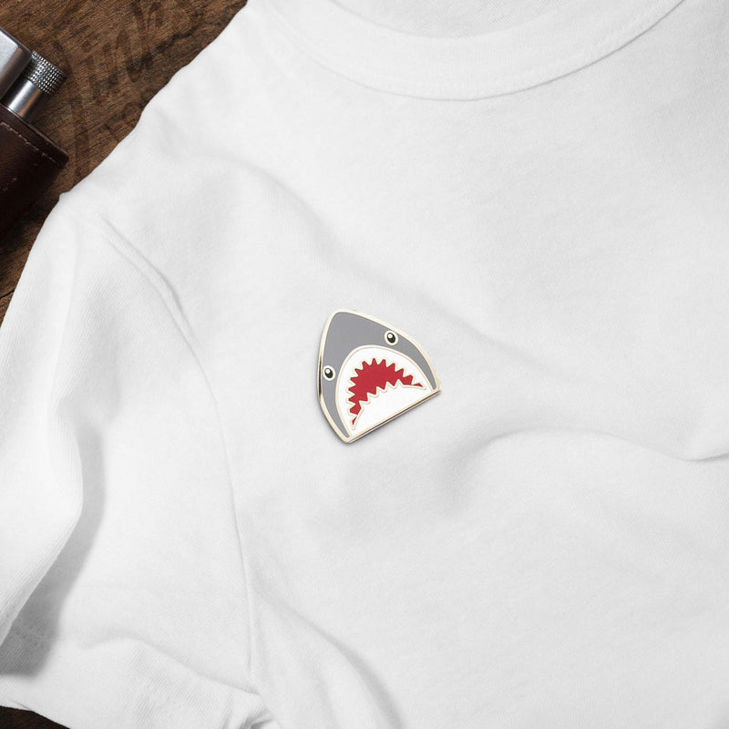 Shark Emoji hard enamel pin on white t-shirt
