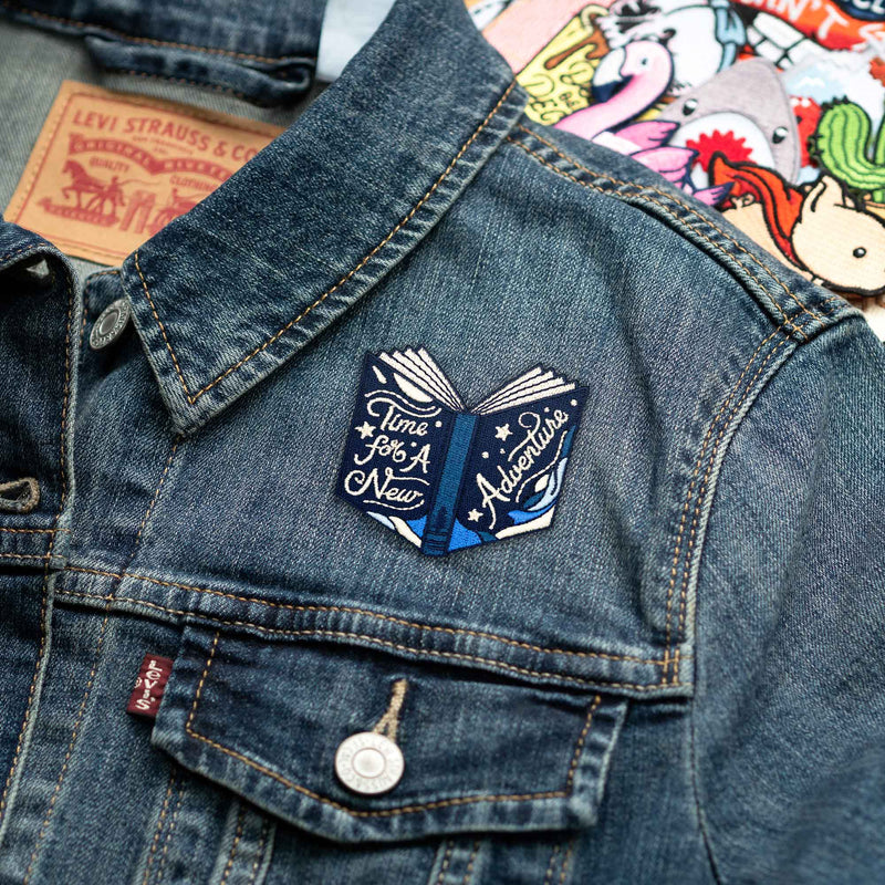 Time For A New Adventure Book patch on denim jacket